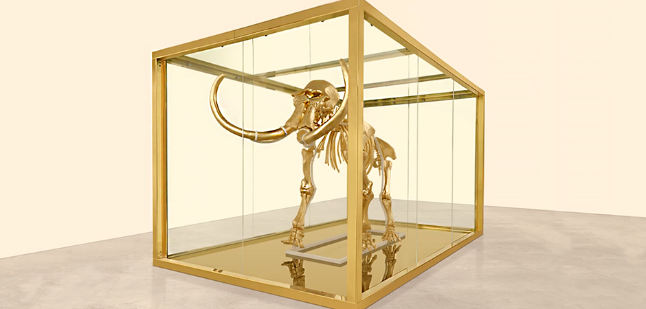 A golden mammoth skeleton in a glass box