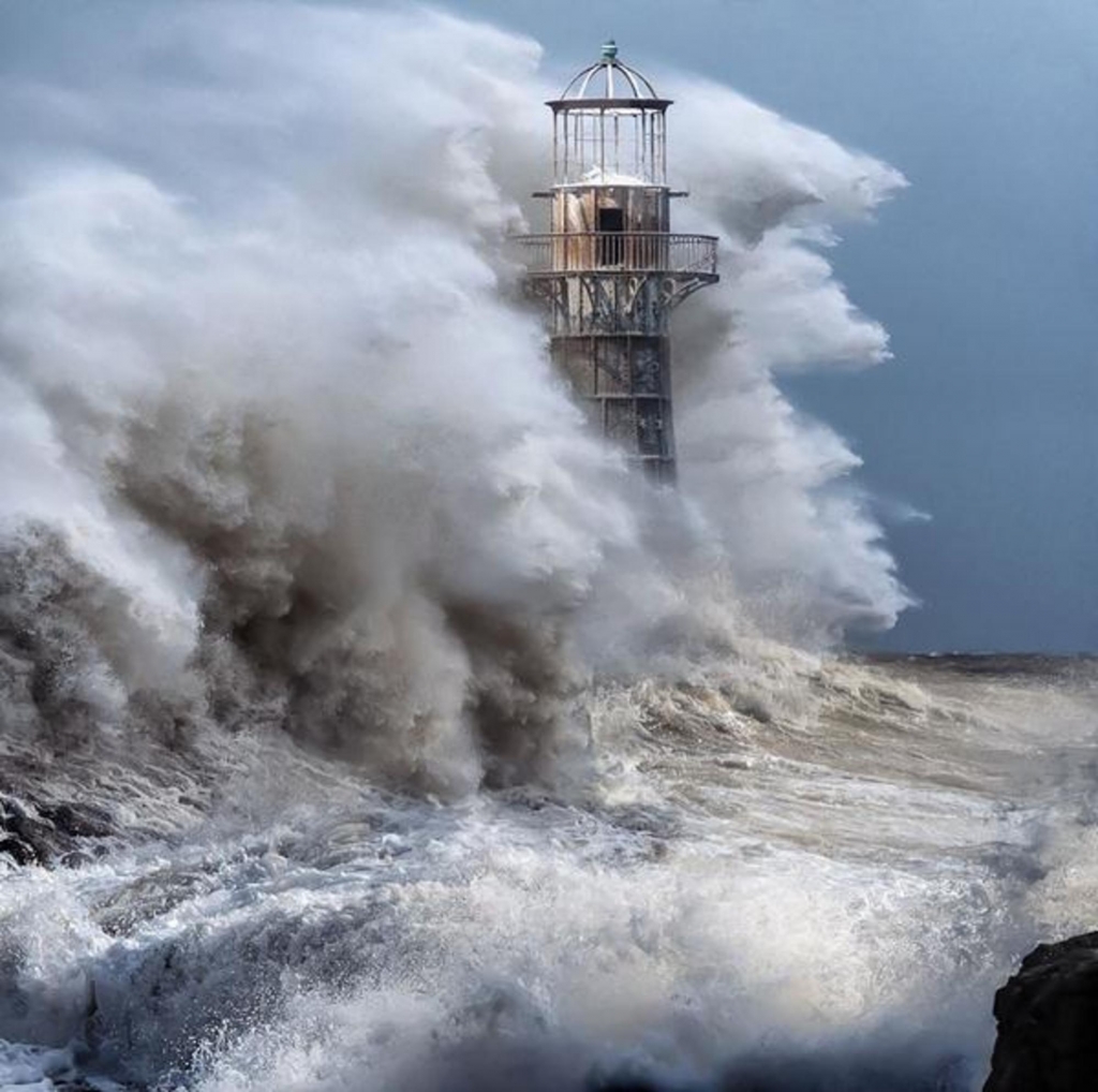 Waves crashing over Whiteford lighthouse 