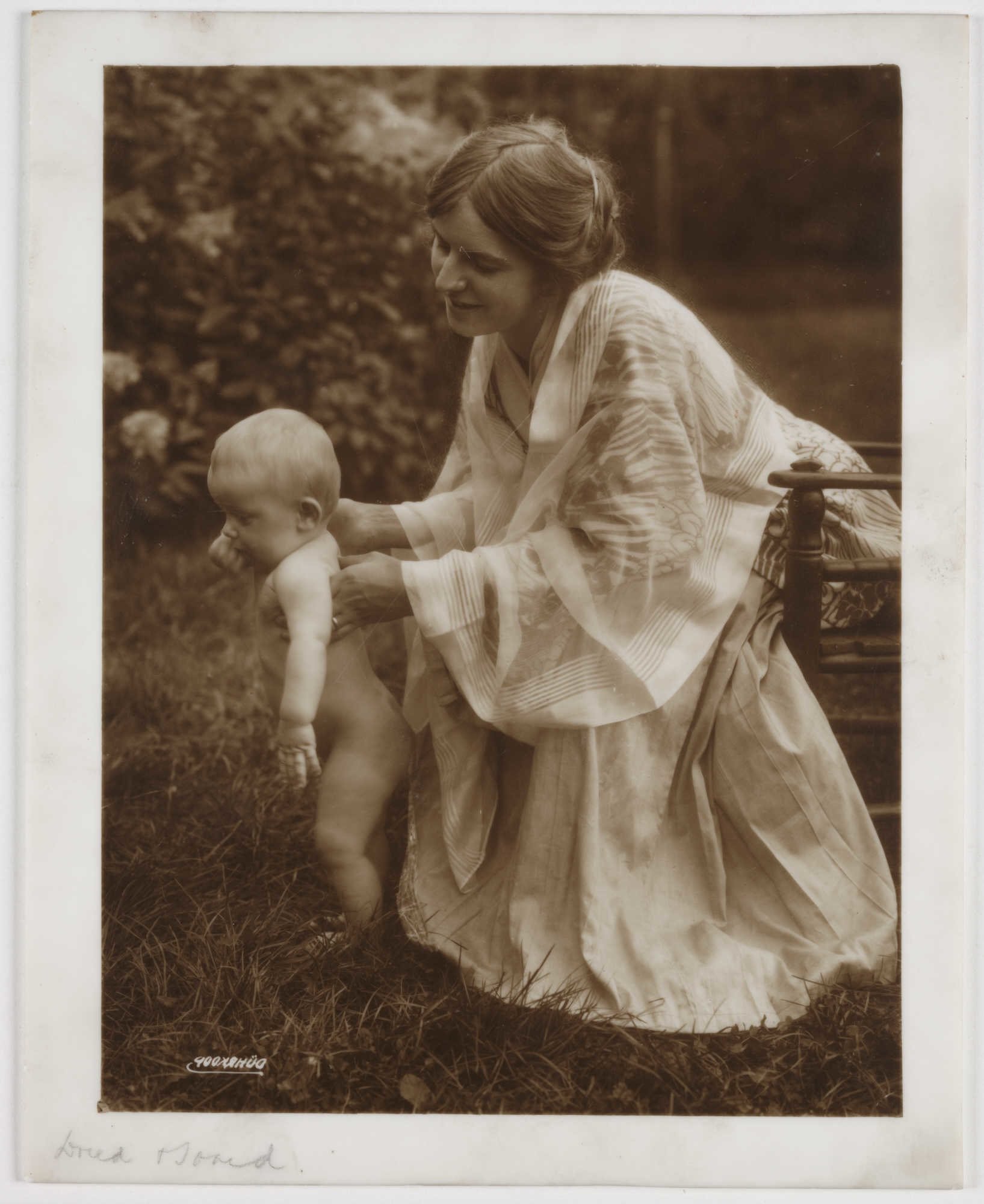 photograph of a mother and child in a garden
