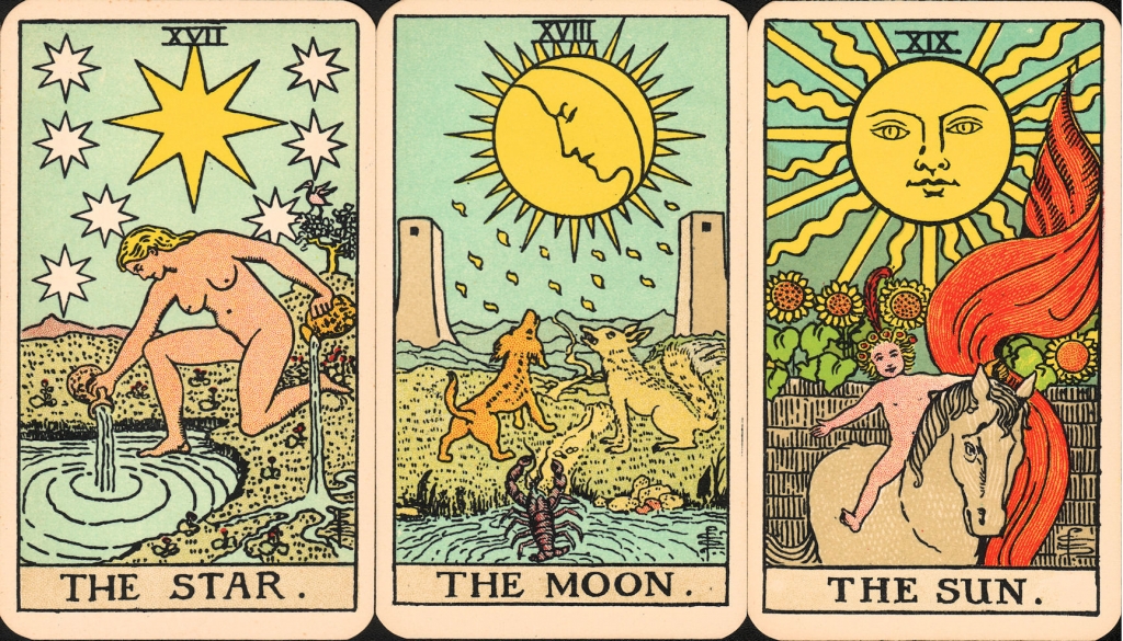 three tarot cards with traditional designs