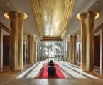 long lobby hallway with six golden columns