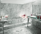 marble bathtub and sink area in hotel suite