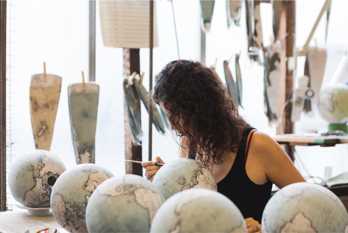 a woman working on nice globes