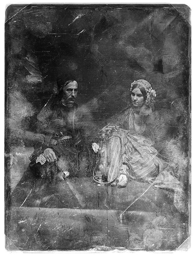 Daguerreotype portrait of a woman and man holding items