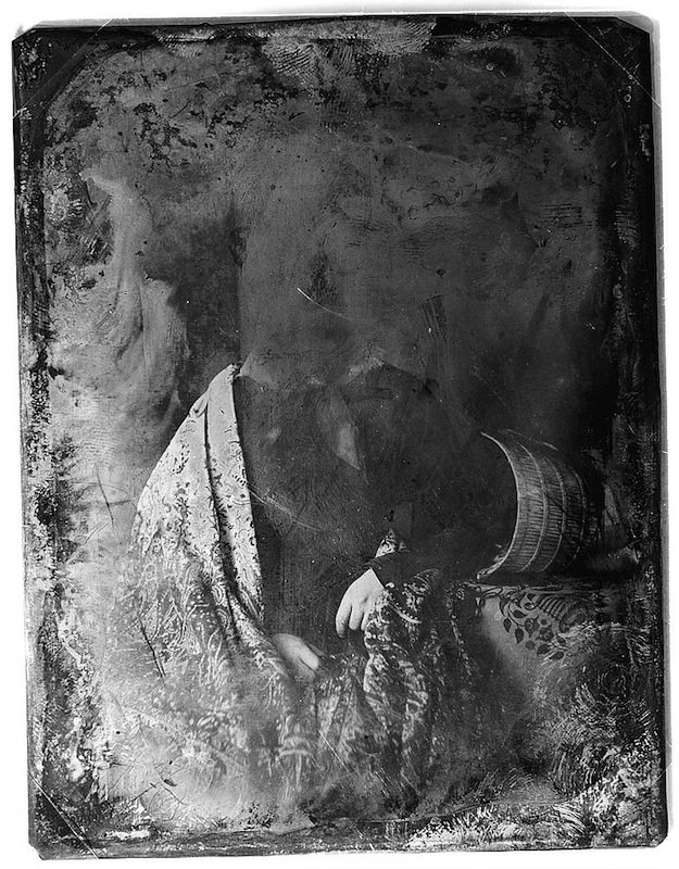 Daguerreotype portrait of a woman resting her head on a table