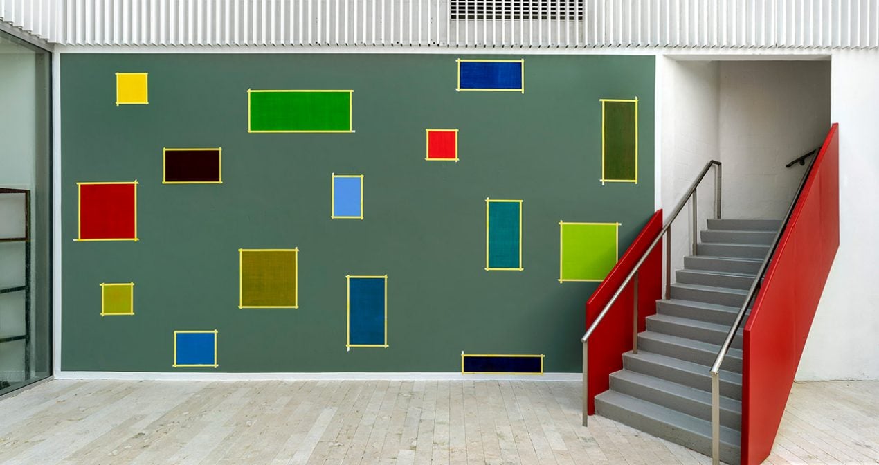 colorful blocks of paint randomly on a gallery wall