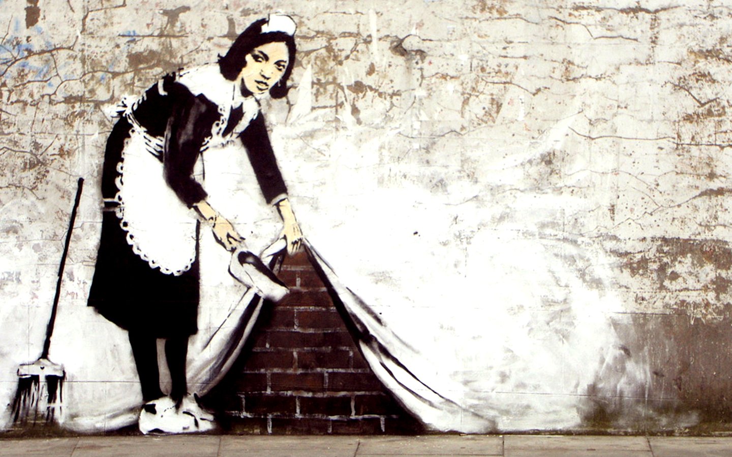 A Banksy artwork of a maid sweeping under a rug.