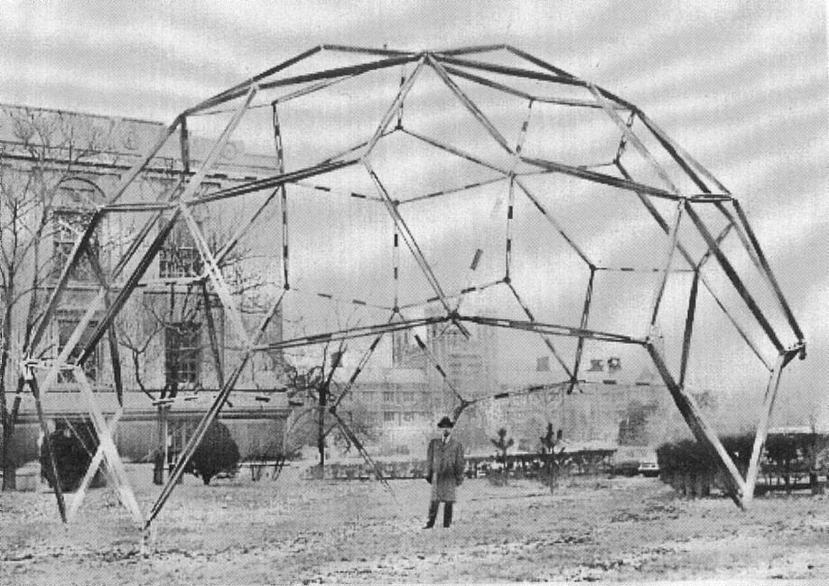 Man stands under metal geometric dome.