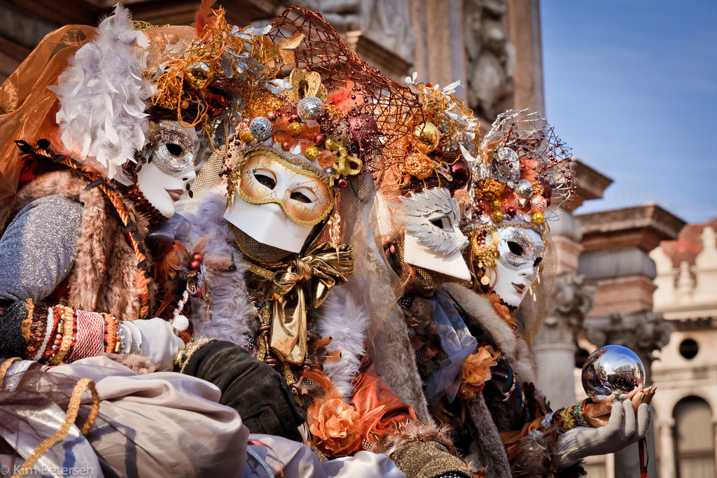 people in costume and masks for venice carnival