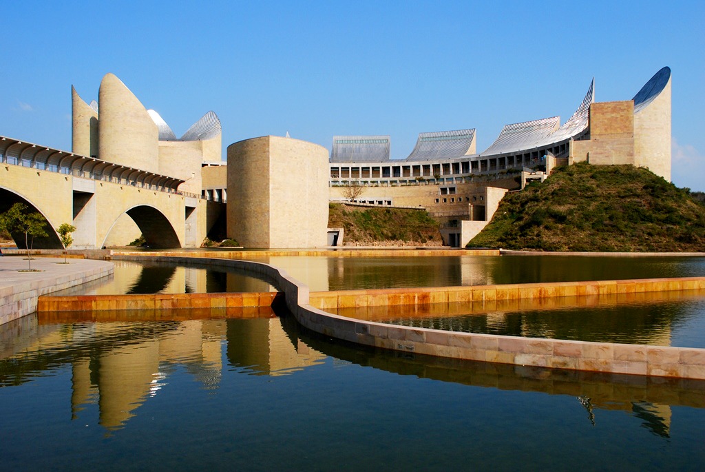 Outside of a large building with a pond