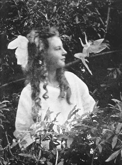 Young girl looking at fairy 
