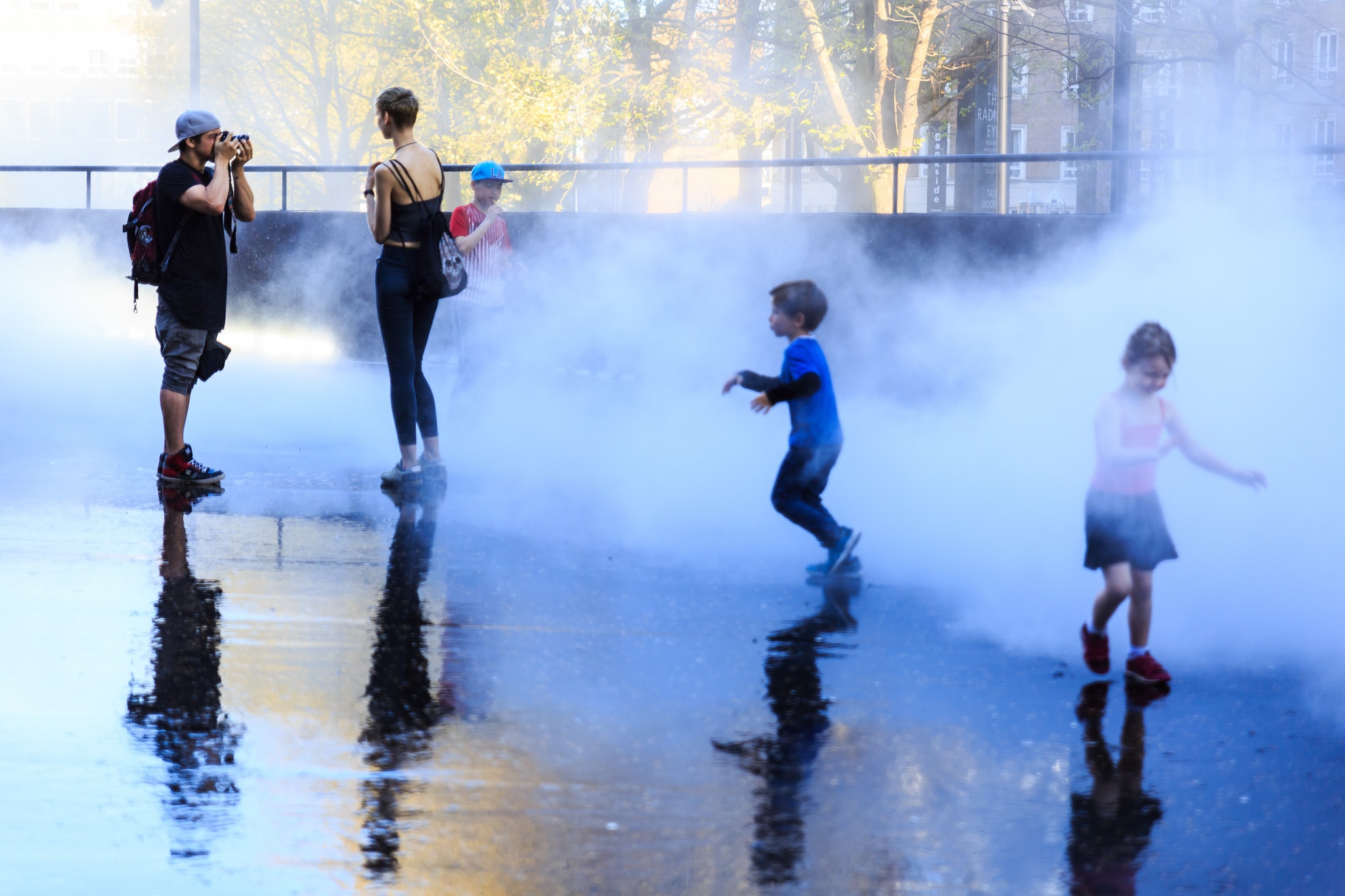 Children plan on a bridge with thick fog