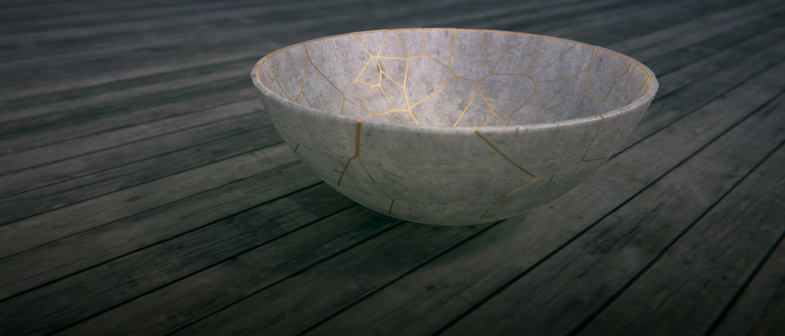 A white japanese bowl with the cracks repaired with gold. 