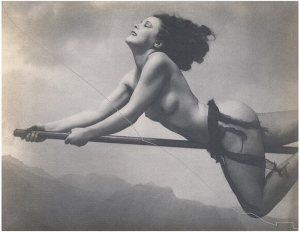 A photograph of a naked women riding a broomstick
