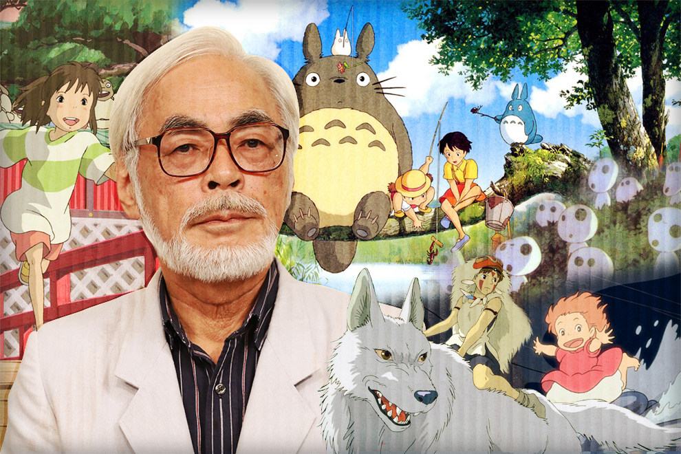 Miyazaki in front of mural of his work