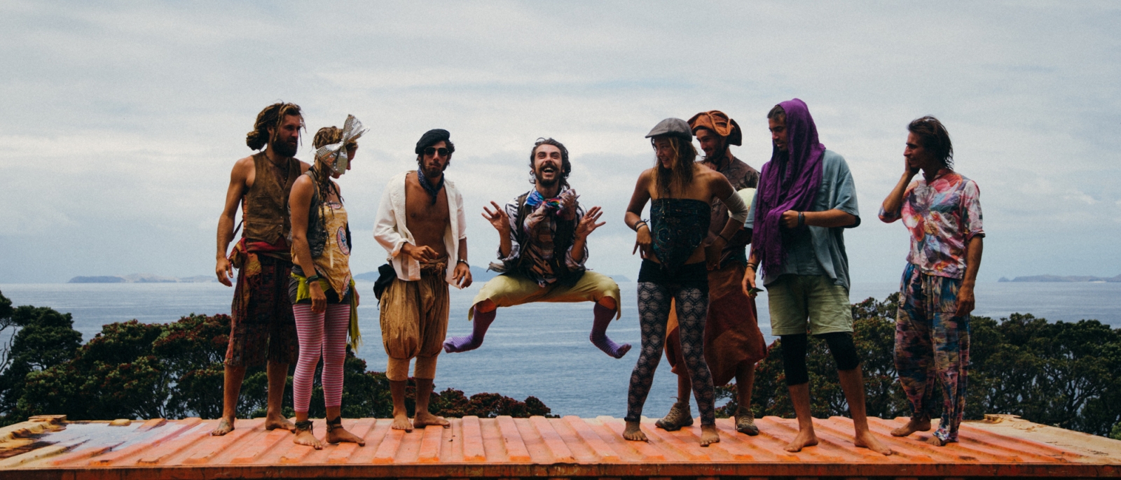 A group on men laughing on a boat dock