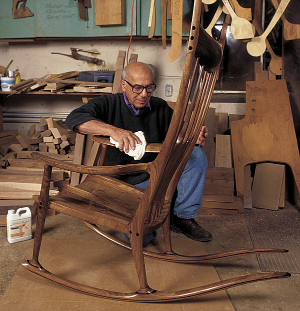 Carpenter Sam Maloof polishes wooden rocking chair