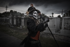 Man dressed as Haitian god Baron Samedi in graveyard