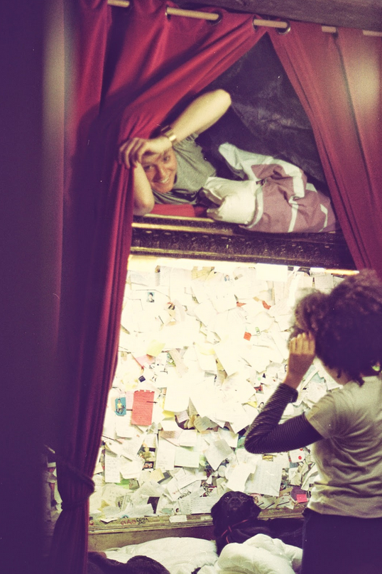 A woman looking at a wall full of pieces of paper