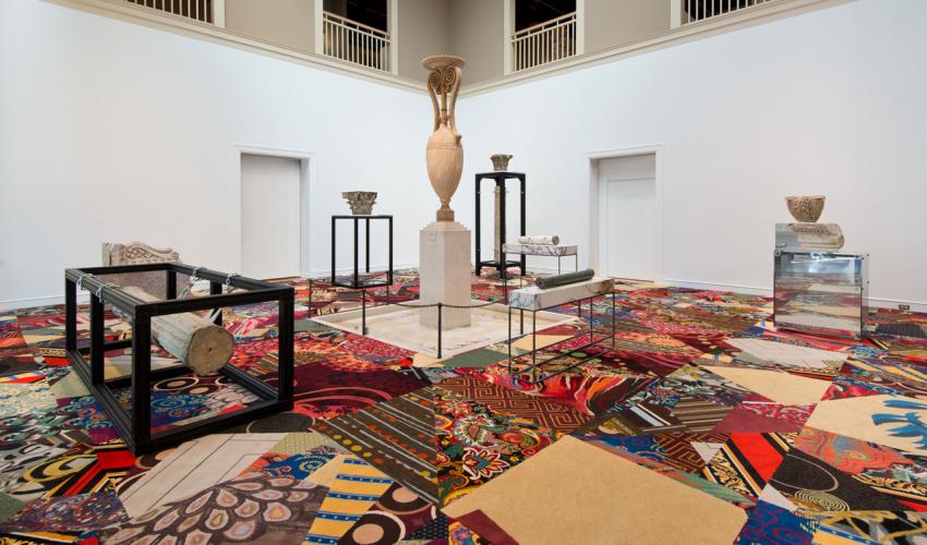 art exhibit of vases on bright colour carpets