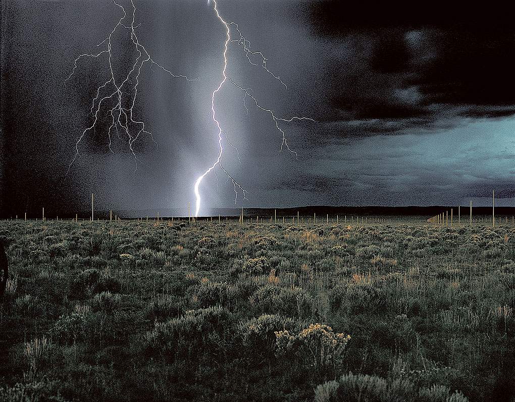 Lightening striking field at night 