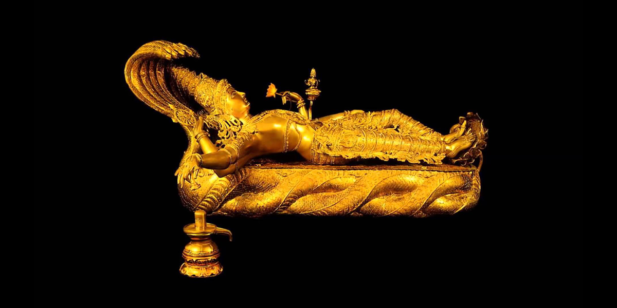 An gold statue of Vishnu laying down