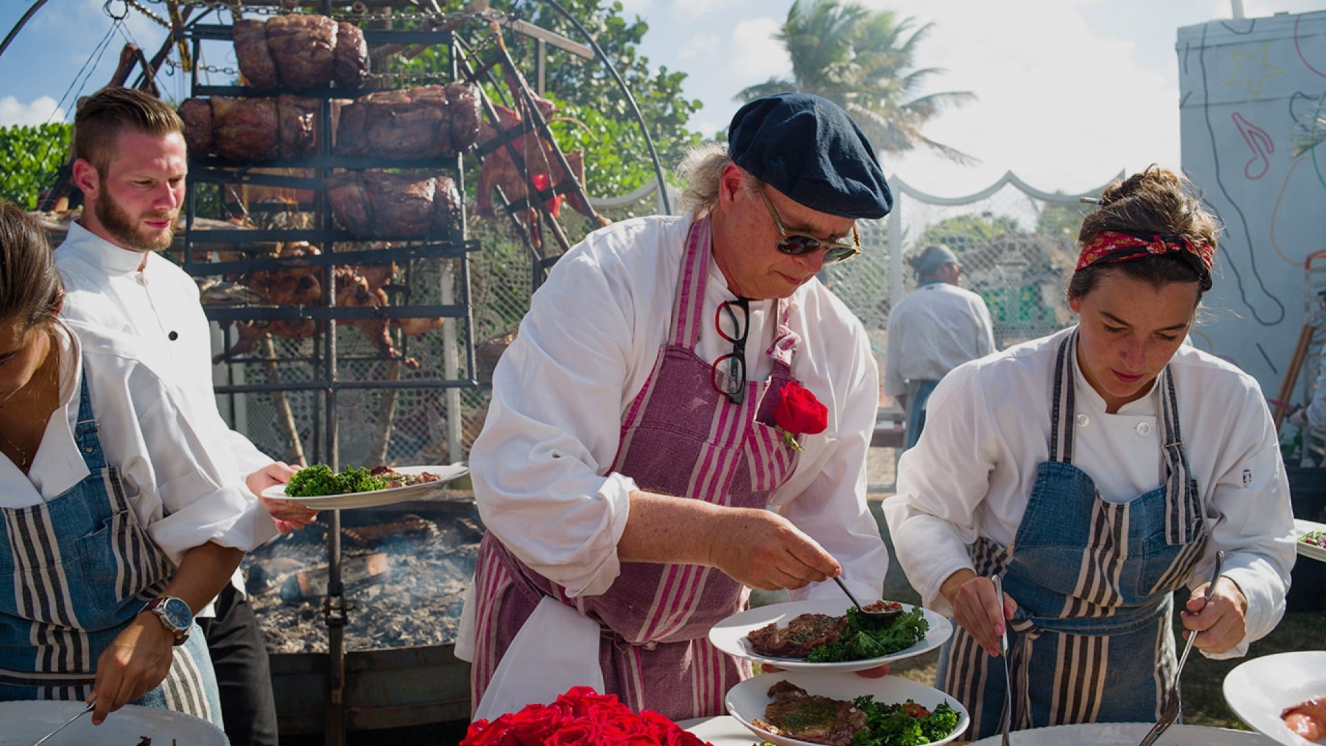 A group of chefs preparing food outdoors