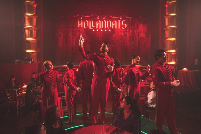 faena theater performers stand in front of stage all wearing red