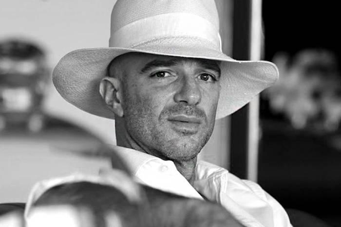 alan faena looking at the camera wearing a white hat