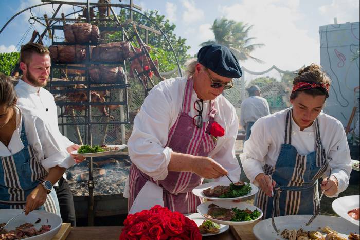 francis mallmann cooking outdoors with assistants