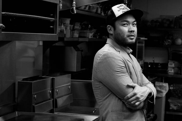 chef paul qui standing with arms crossed looking at camera