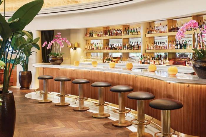 Fancy bar lined with stools