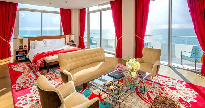 hotel bedroom with sitting area containing couch and two chairs