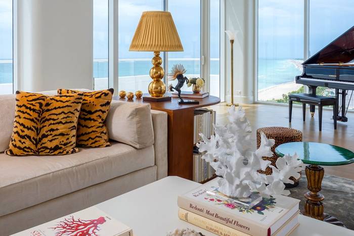 couch in hotel penthouse with grand piano behind