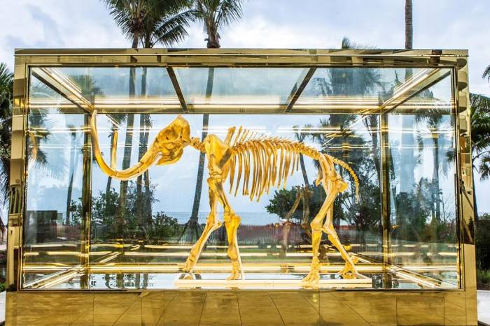 A gold mammoth in a glass box