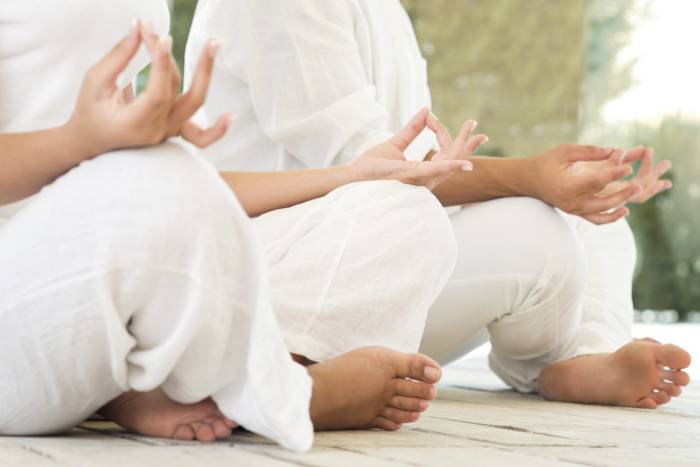 two people sitting in lotus position