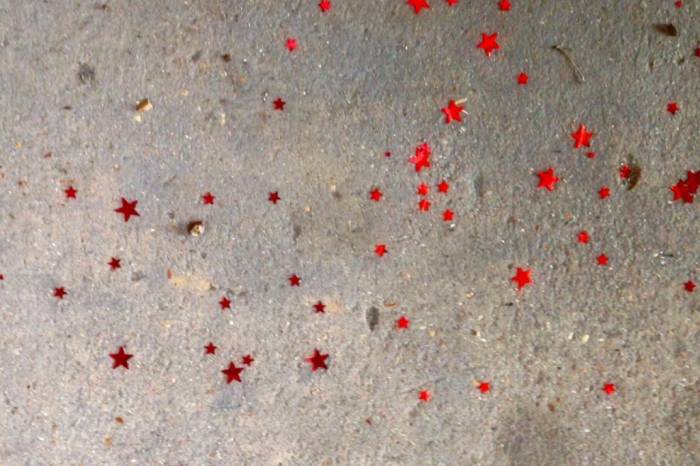 red starts on a cement background
