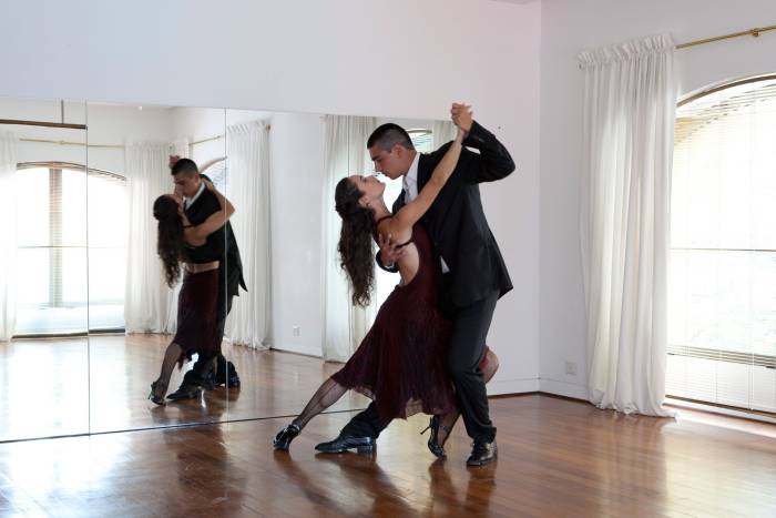 two couples dance the tango