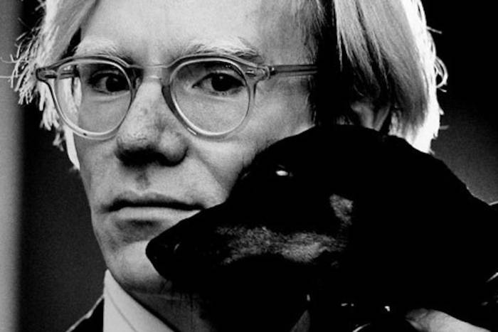 Photograph of Andy Warhol and a dog