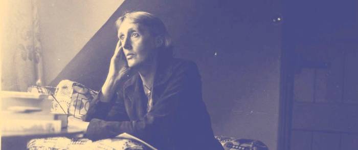 Author Virginia Woolf looks out window sitting at desk