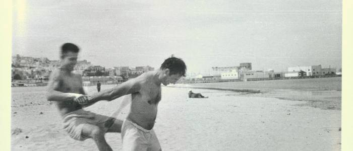 Jack Kerouac and Peter Orlovsky horsing around on the beach