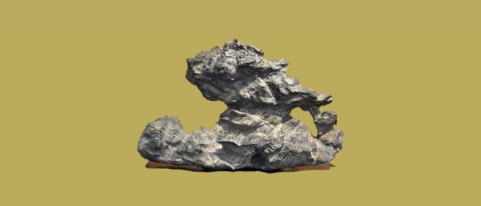 Jagged silver rock on mustard yellow background.