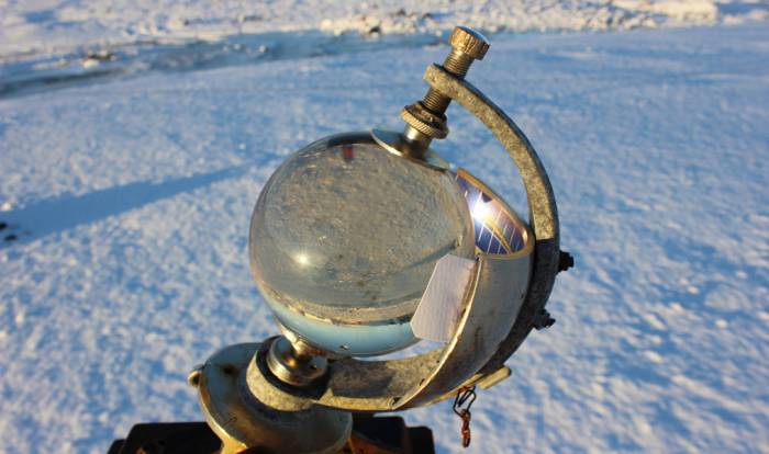 Crystal ball sitting in snow 