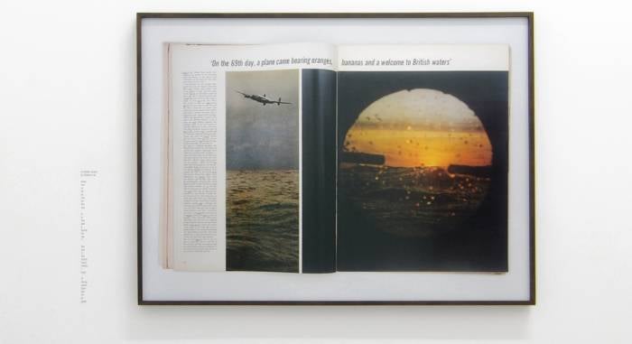 Book laying open to picture of sunset.