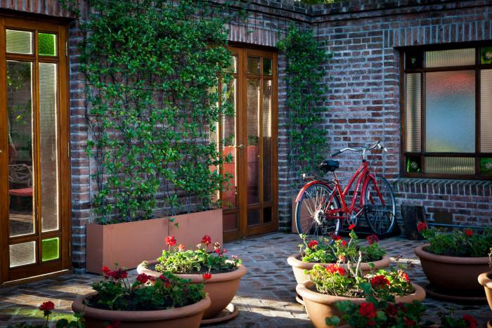 bicycle sits against brick wall exterior of building