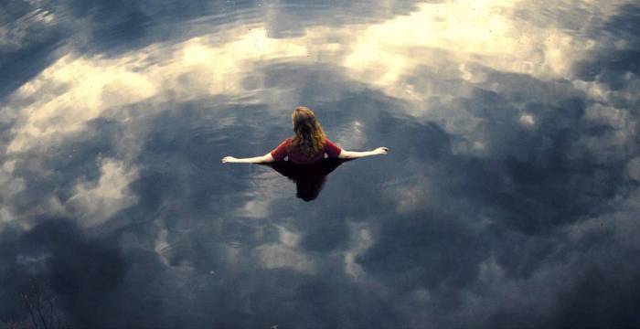 Woman in still lake