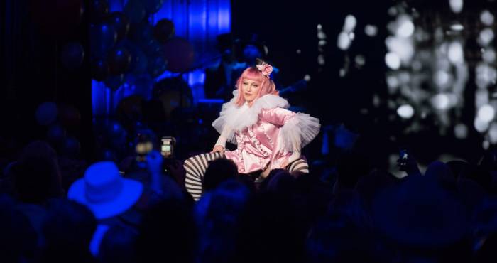 madonna performs on stage wearing pink wig and black & white striped socks