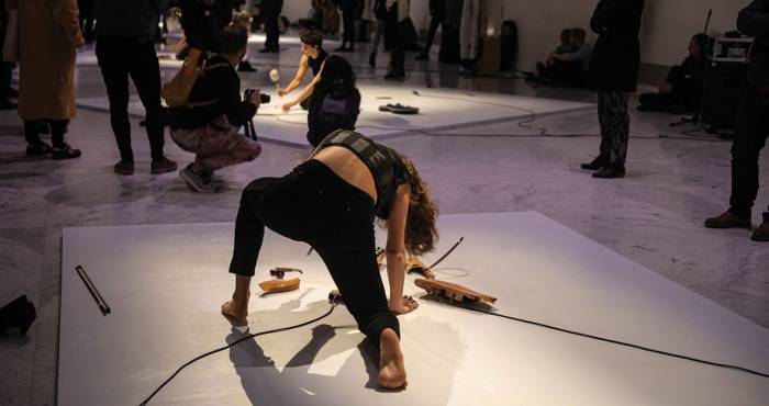 woman dressed in black performs on ground