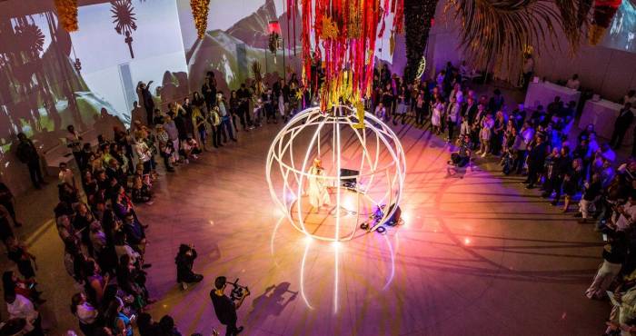 birds eye view of white sphere stage surrounded by group of people