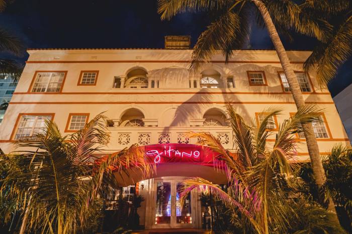 exterior front-side of Gitano MIami with lit-up pink neon sign